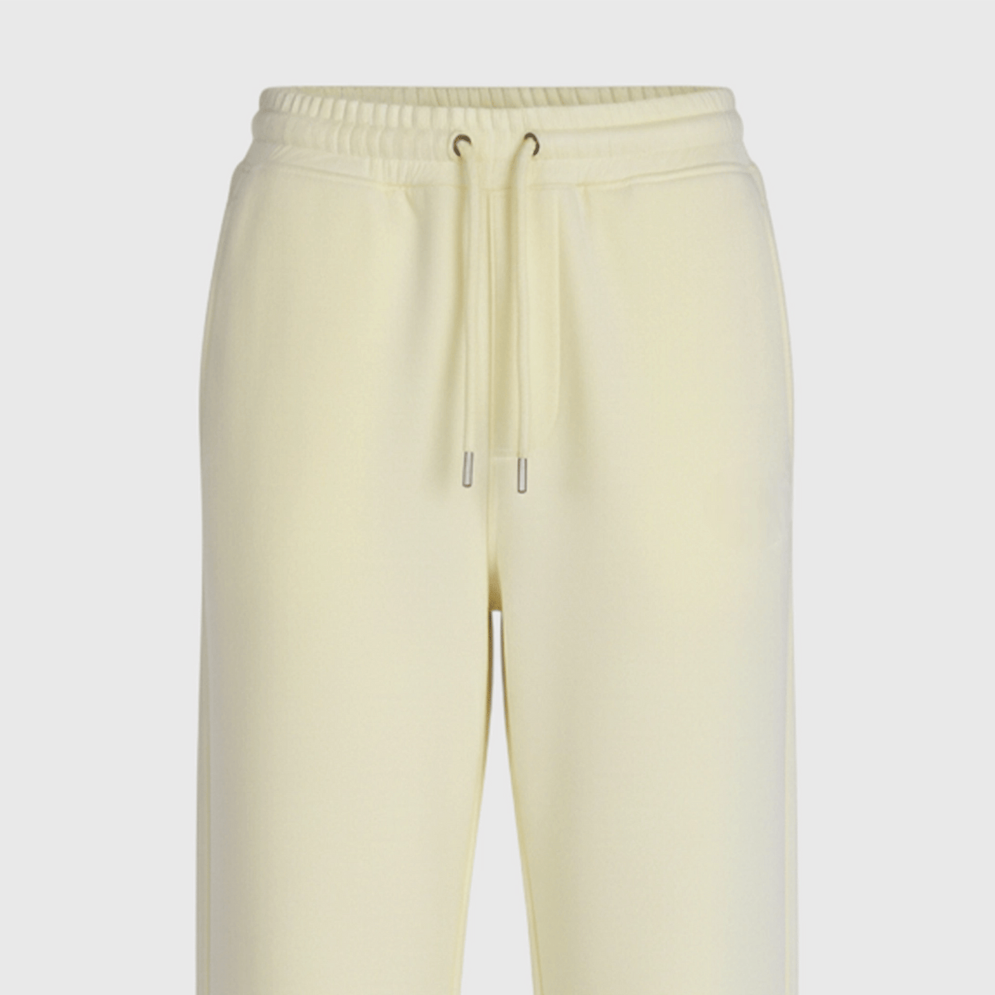 Light yellow sweatpants on a light gray background