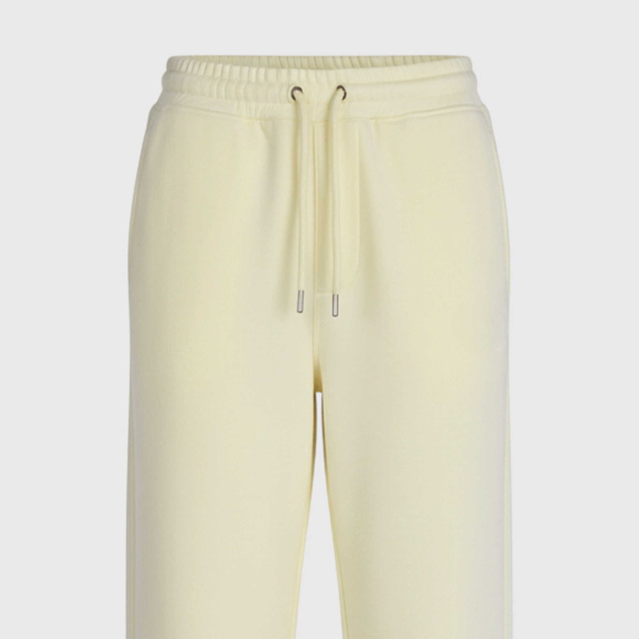 Light yellow sweatpants on a light gray background