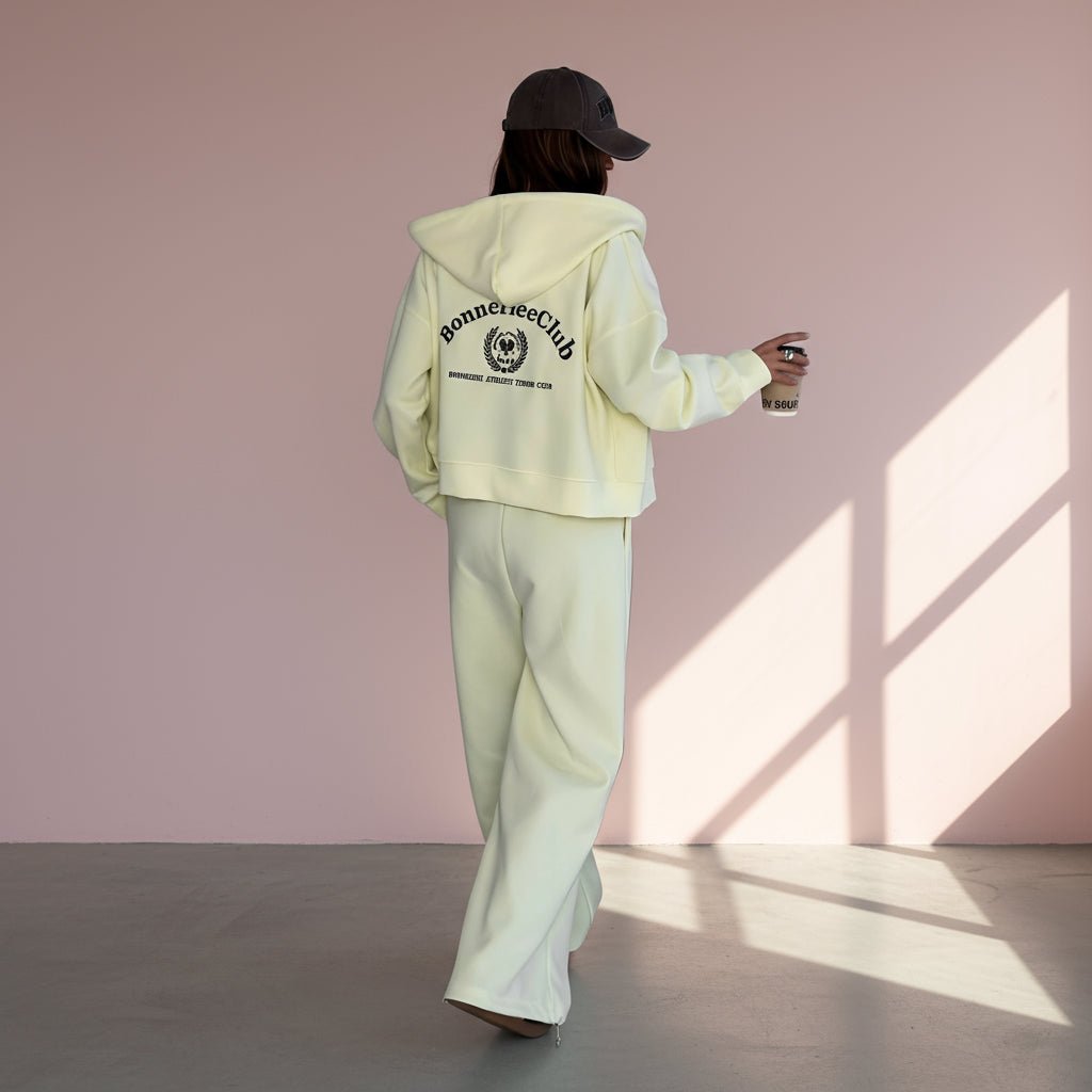 Person wearing a  hoodie and pants with 'Bonnefete Club' text, standing against a plain background.