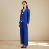 Woman wearing a blue suit with gold buttons on a gray background