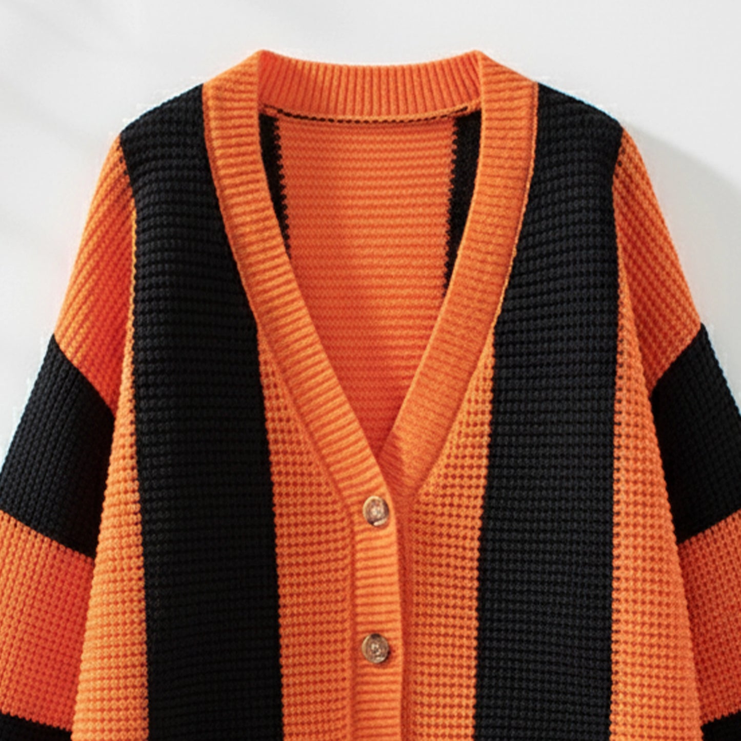Black and orange striped cardigan on a white background