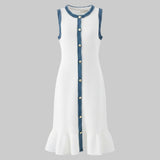 White dress with blue trim and buttons on a gray background