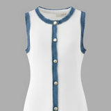 White dress with blue denim trim and buttons on a gray background