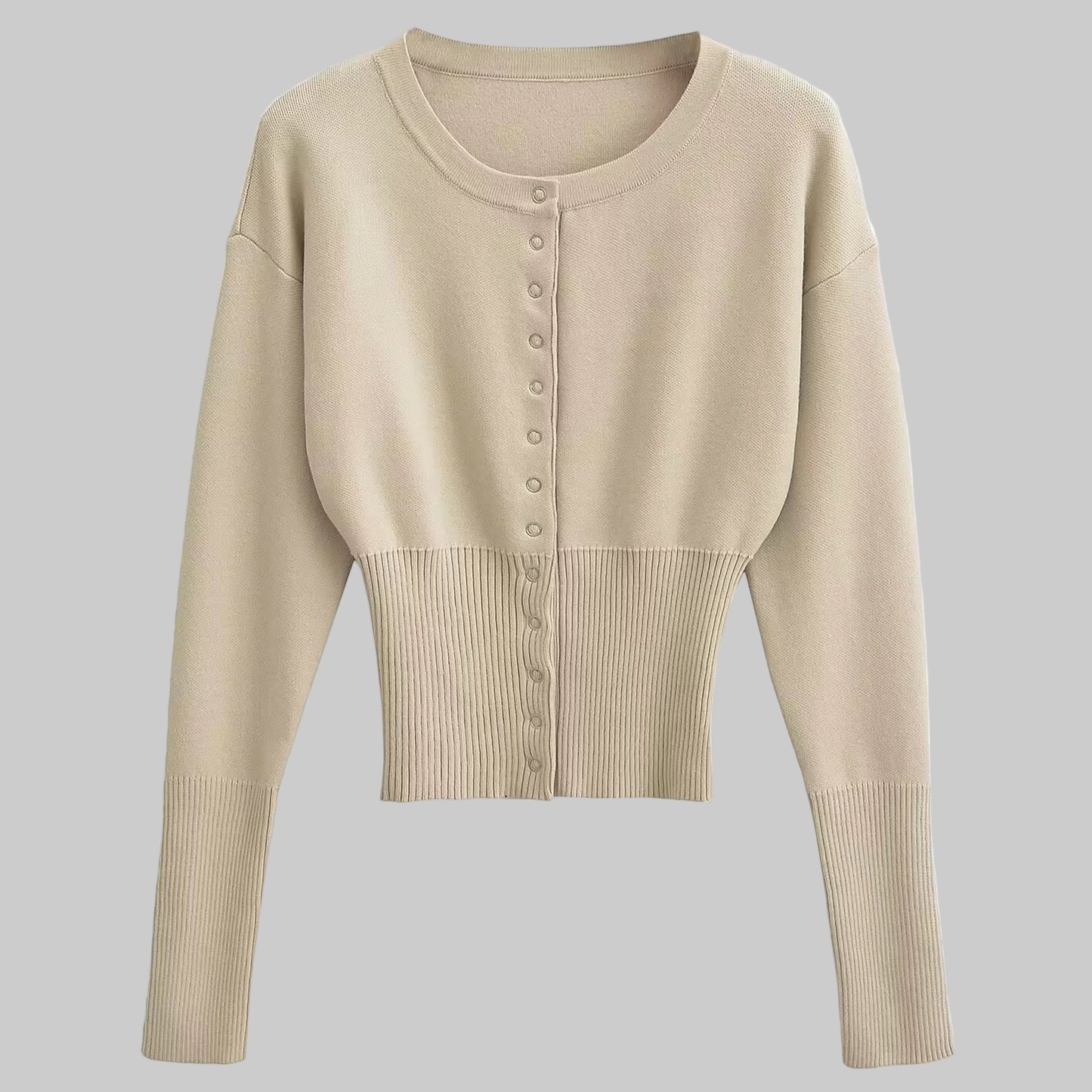 Beige cropped cardigan with button details on a light gray background