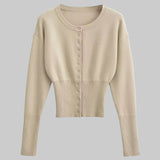 Beige cropped cardigan with button details on a light gray background