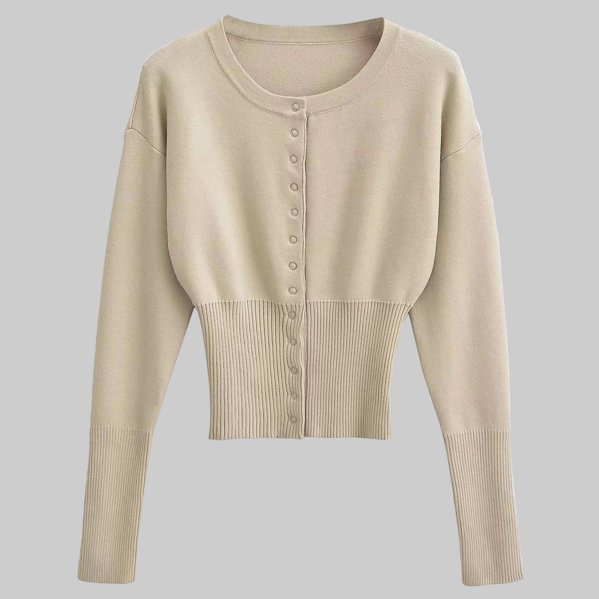 Beige cropped cardigan with button details on a light gray background