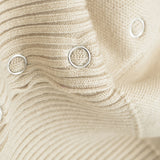 Close-up of beige fabric with circular patterns and buttons