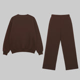 Brown sweatshirt and pants set on a light gray background