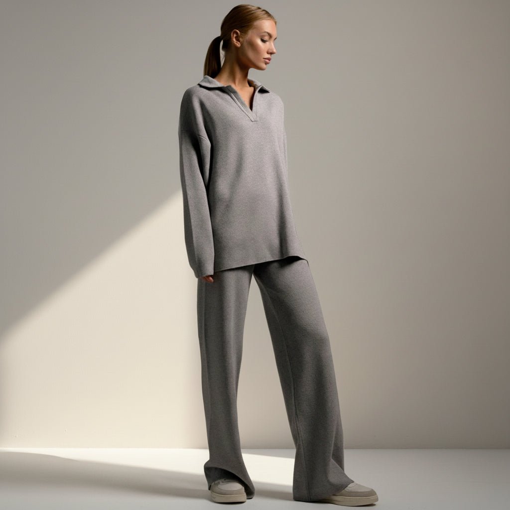 Woman wearing a gray outfit on a plain background