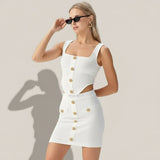 Woman wearing a white dress with gold buttons on a gray background