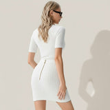 Woman wearing a white ribbed dress with a gold zipper on a gray background