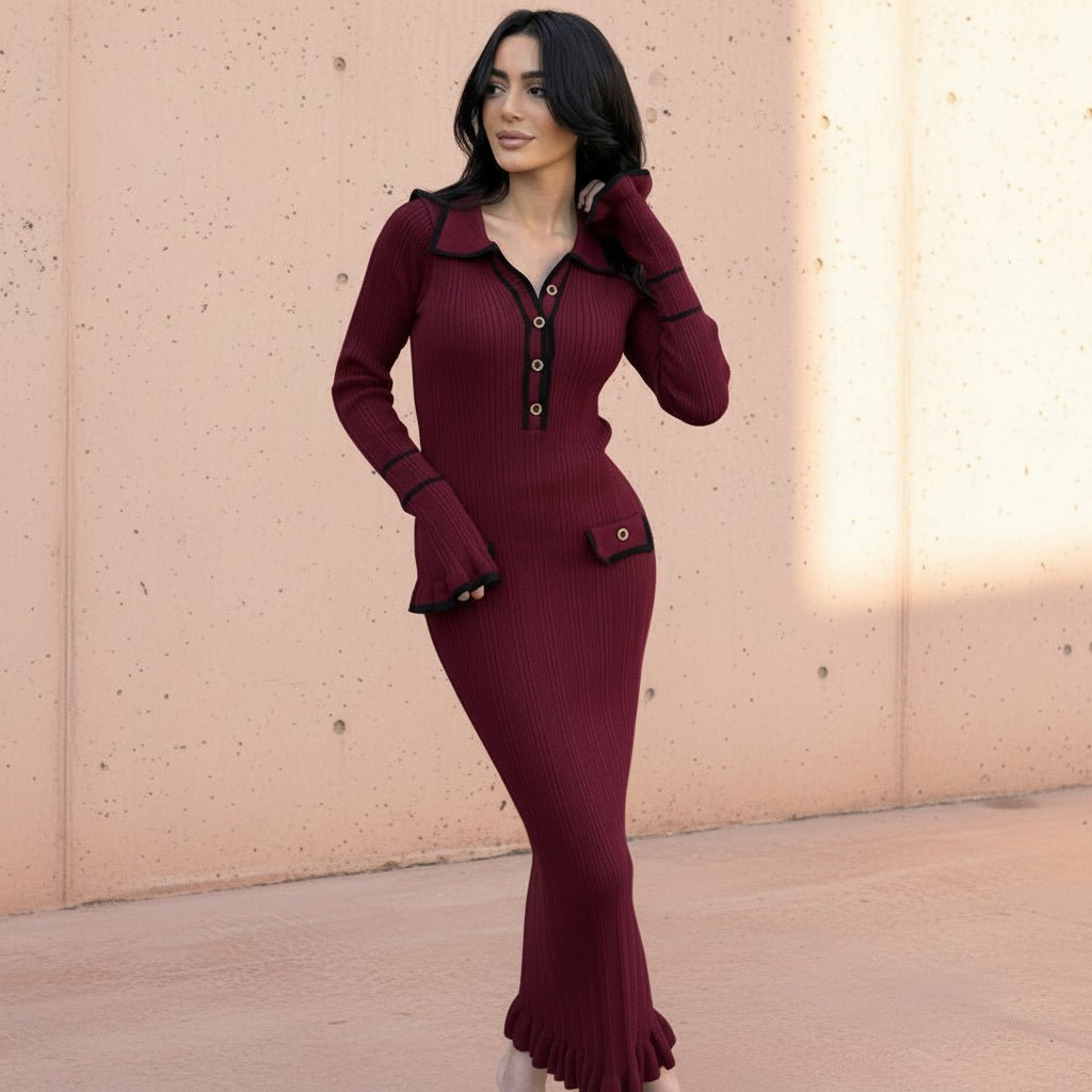 Woman wearing a burgundy dress with black trim on a gray background