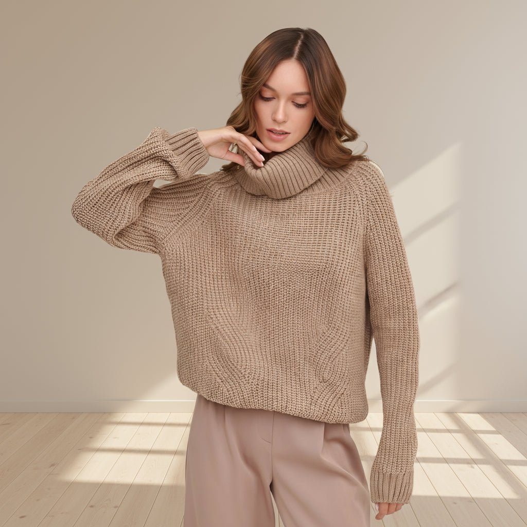 Woman wearing a beige knitted sweater on a gray background