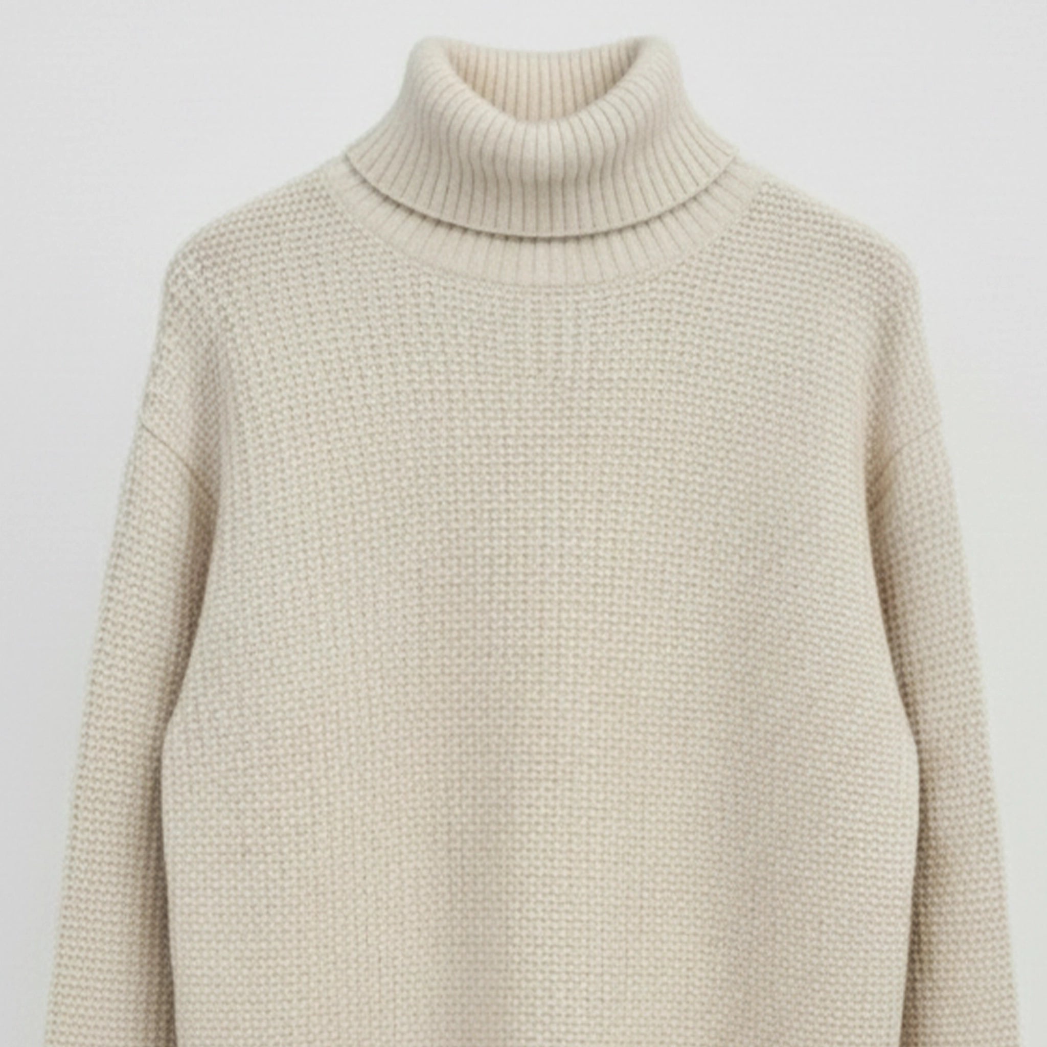 Beige turtleneck sweater on a light gray background
