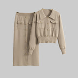 Beige shirt and skirt set on hangers against a gray background