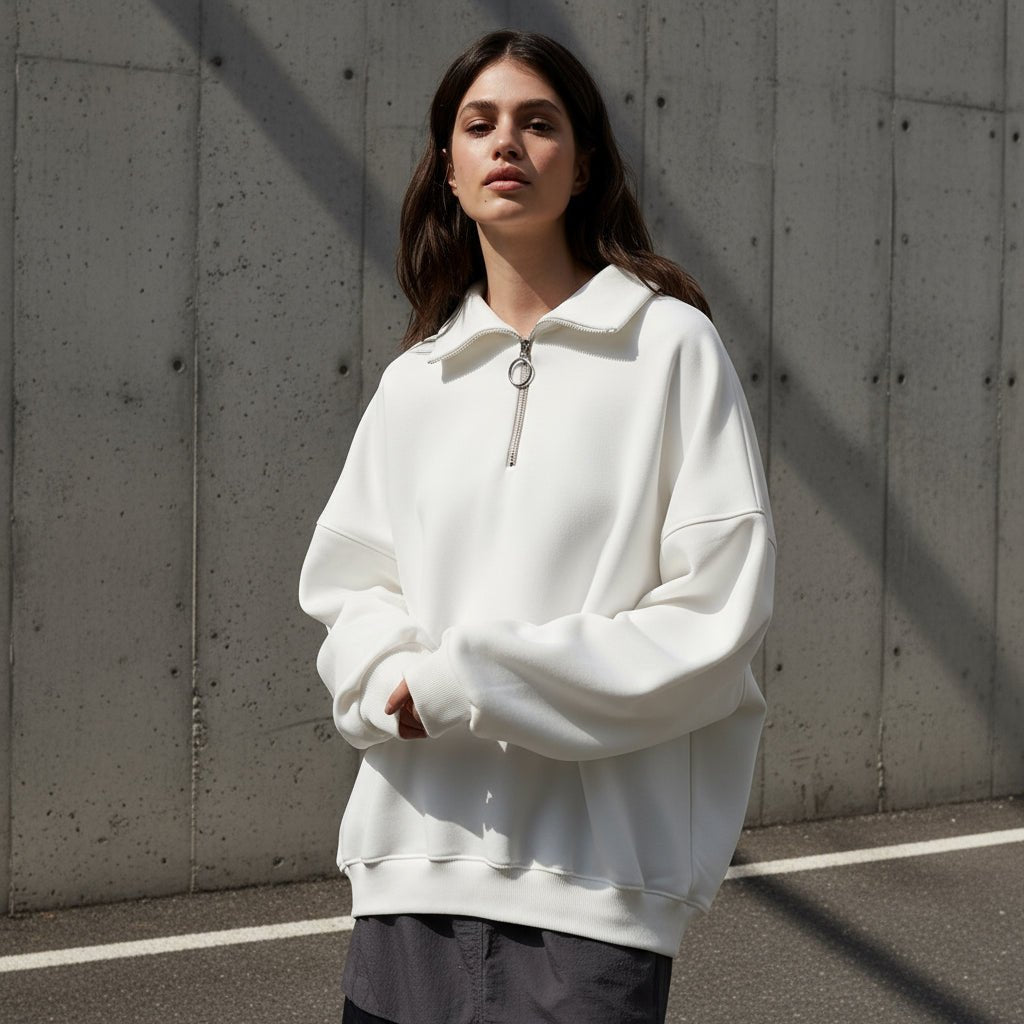 Woman wearing a white hoodie on a gray background