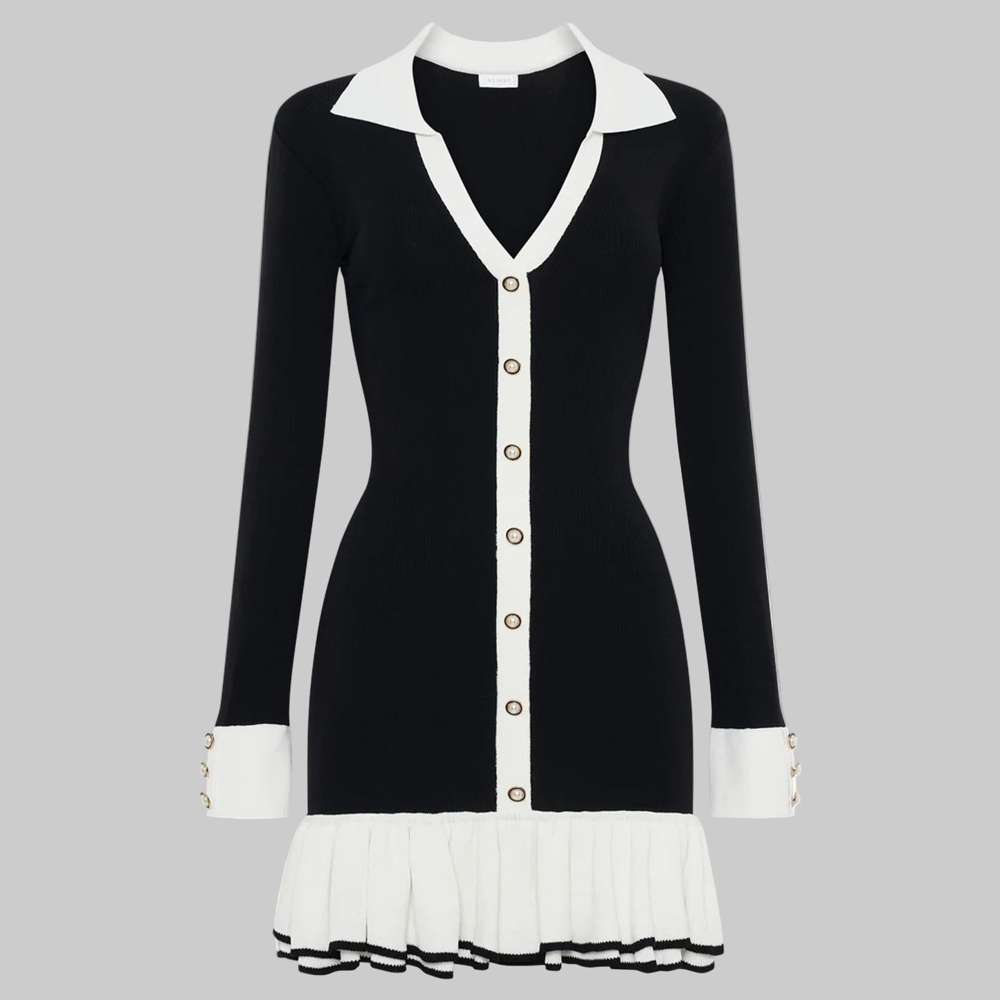 Black and white dress with a V-neckline and pleated skirt on a white background