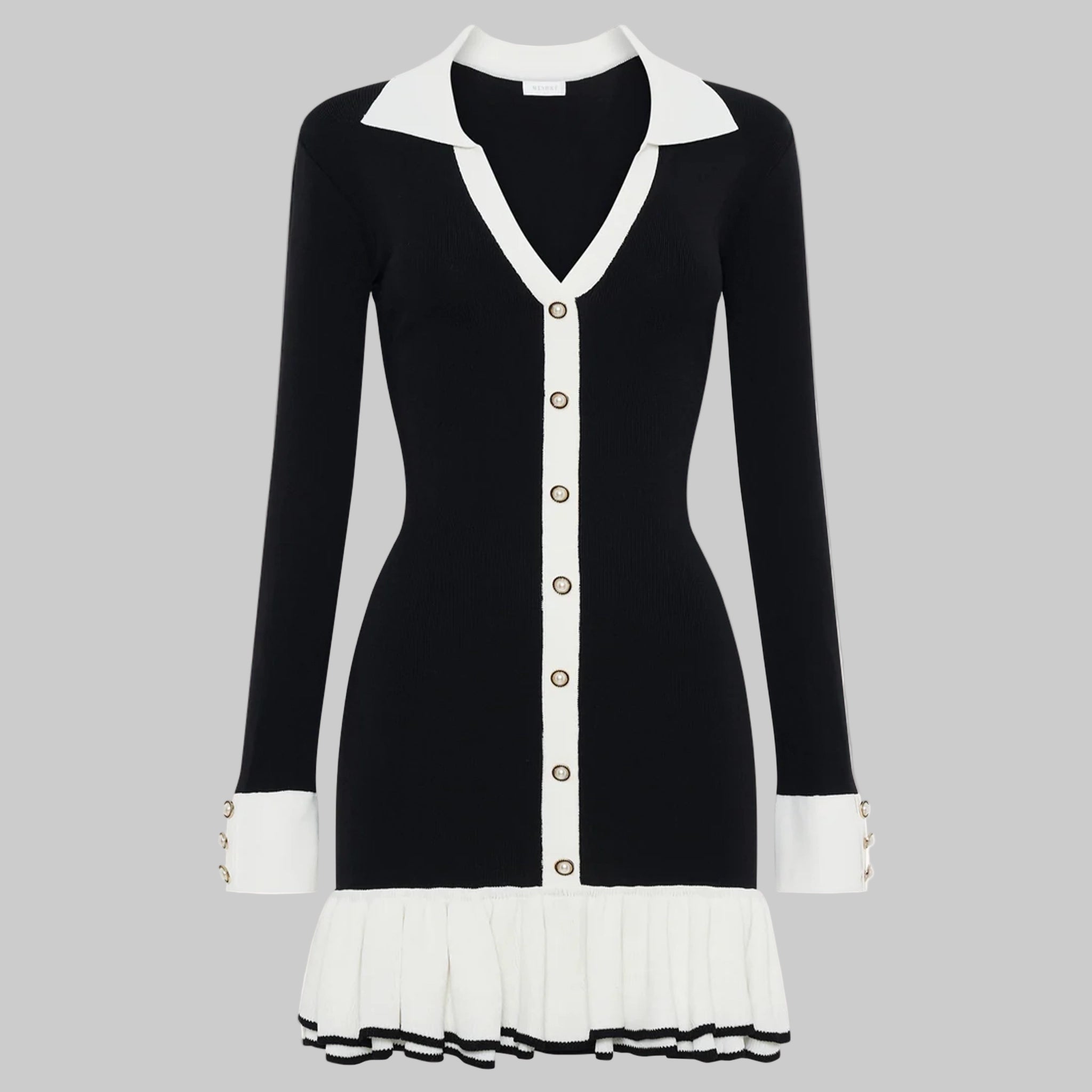 Black and white dress with a V-neckline and pleated skirt on a white background