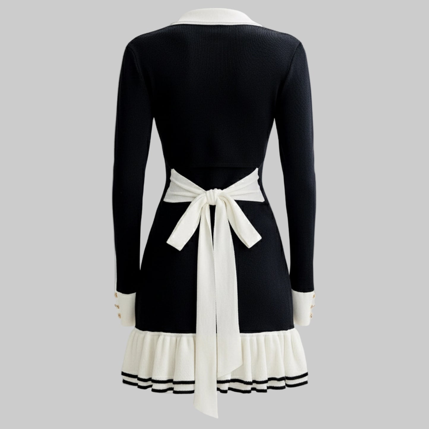 Black dress with white accents on a gray background