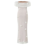 White off-shoulder top with polka dots on a white background