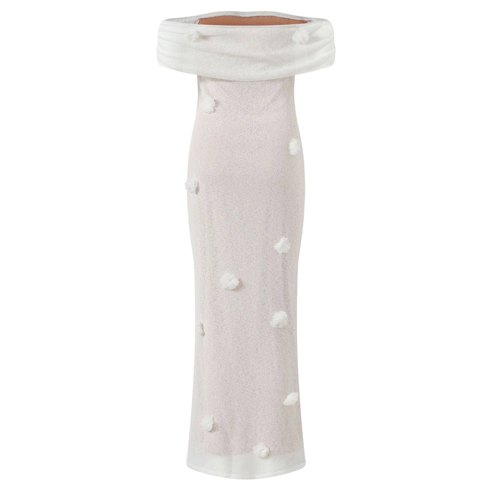 White off-shoulder top with polka dots on a white background