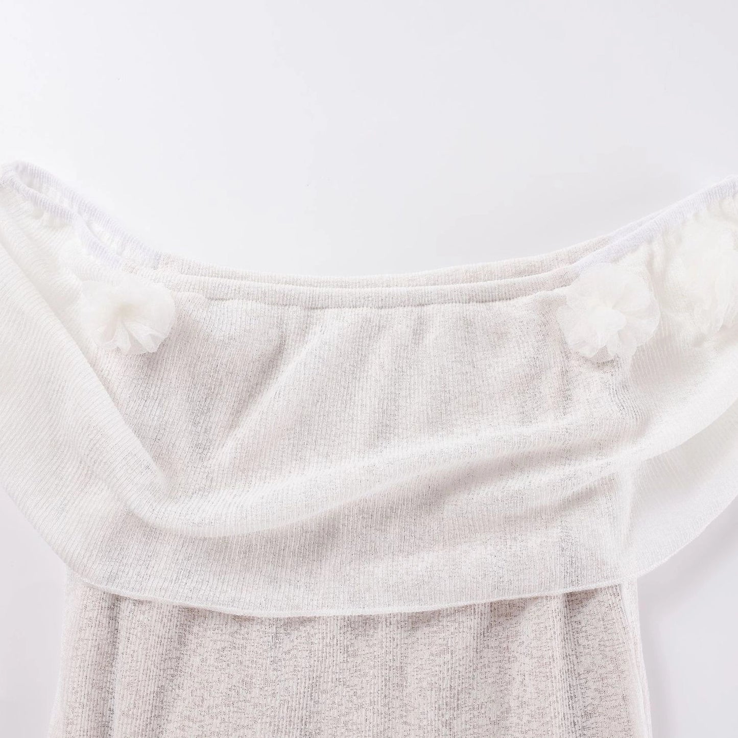 Close-up of a textured white fabric on a light gray background