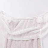 Close-up of a textured white fabric on a light gray background