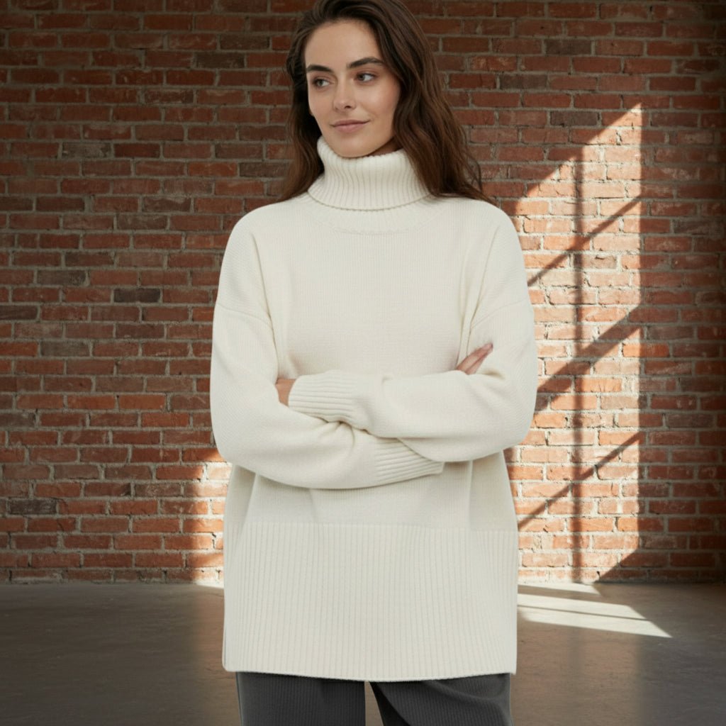 Woman wearing a cream turtleneck sweater against a plain background