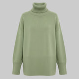 Green turtleneck sweater on a white background