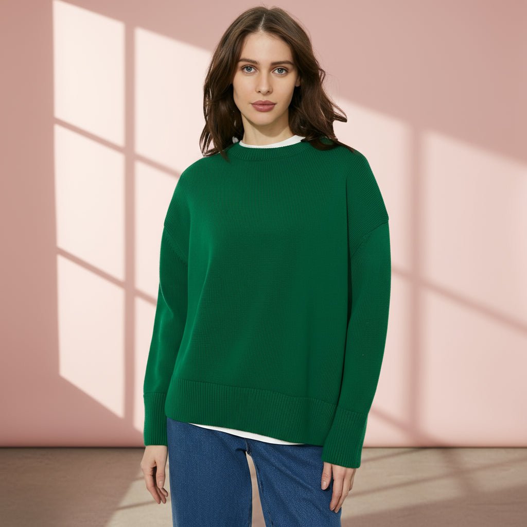Woman wearing a green sweater on a gray background