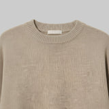 Beige sweater on a light gray background