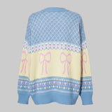 Sweater with pink bows and decorative patterns on a gray background