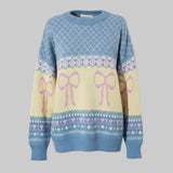 Sweater with bow and heart patterns on a gray background