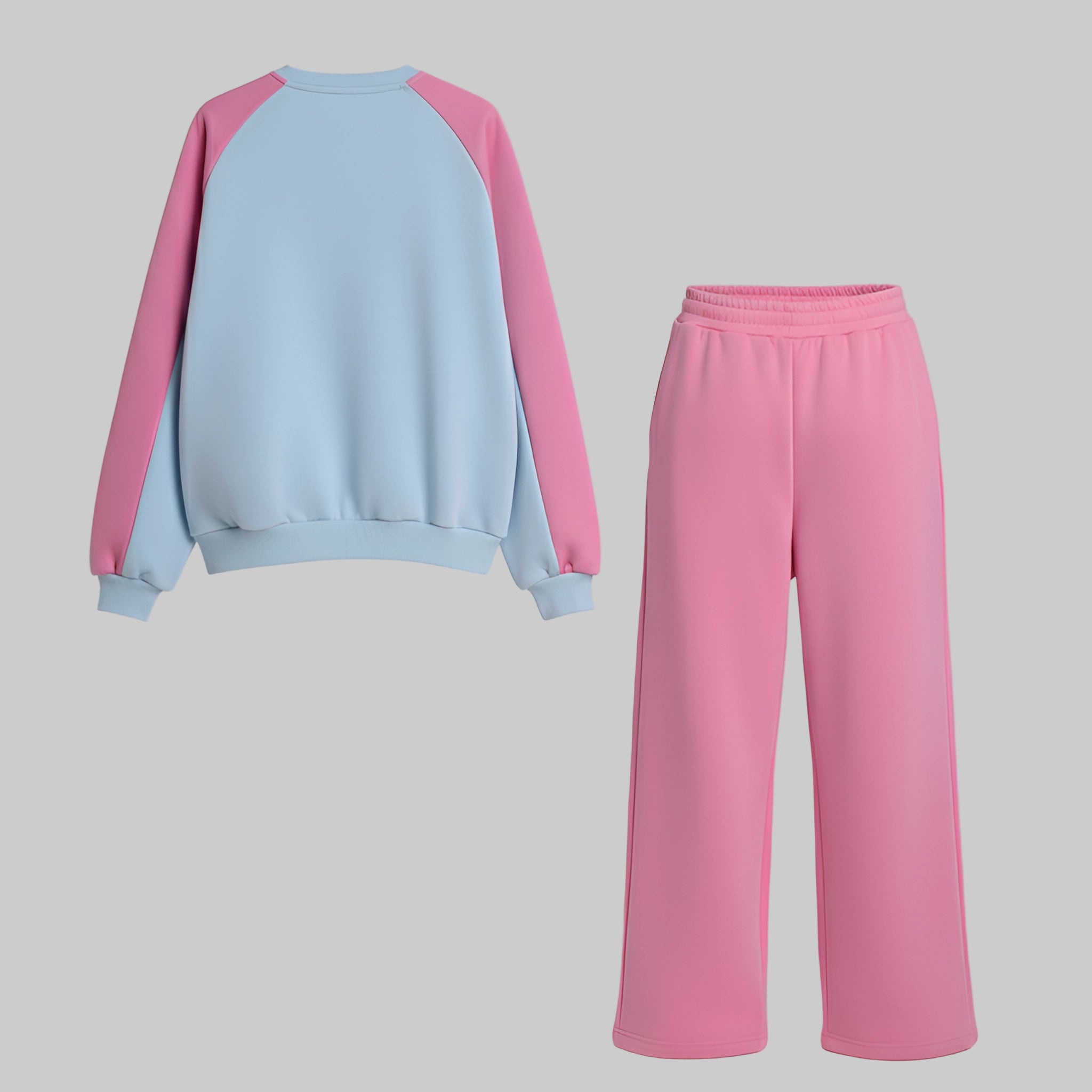 Light blue and pink sweatshirt with matching pink pants on a gray background