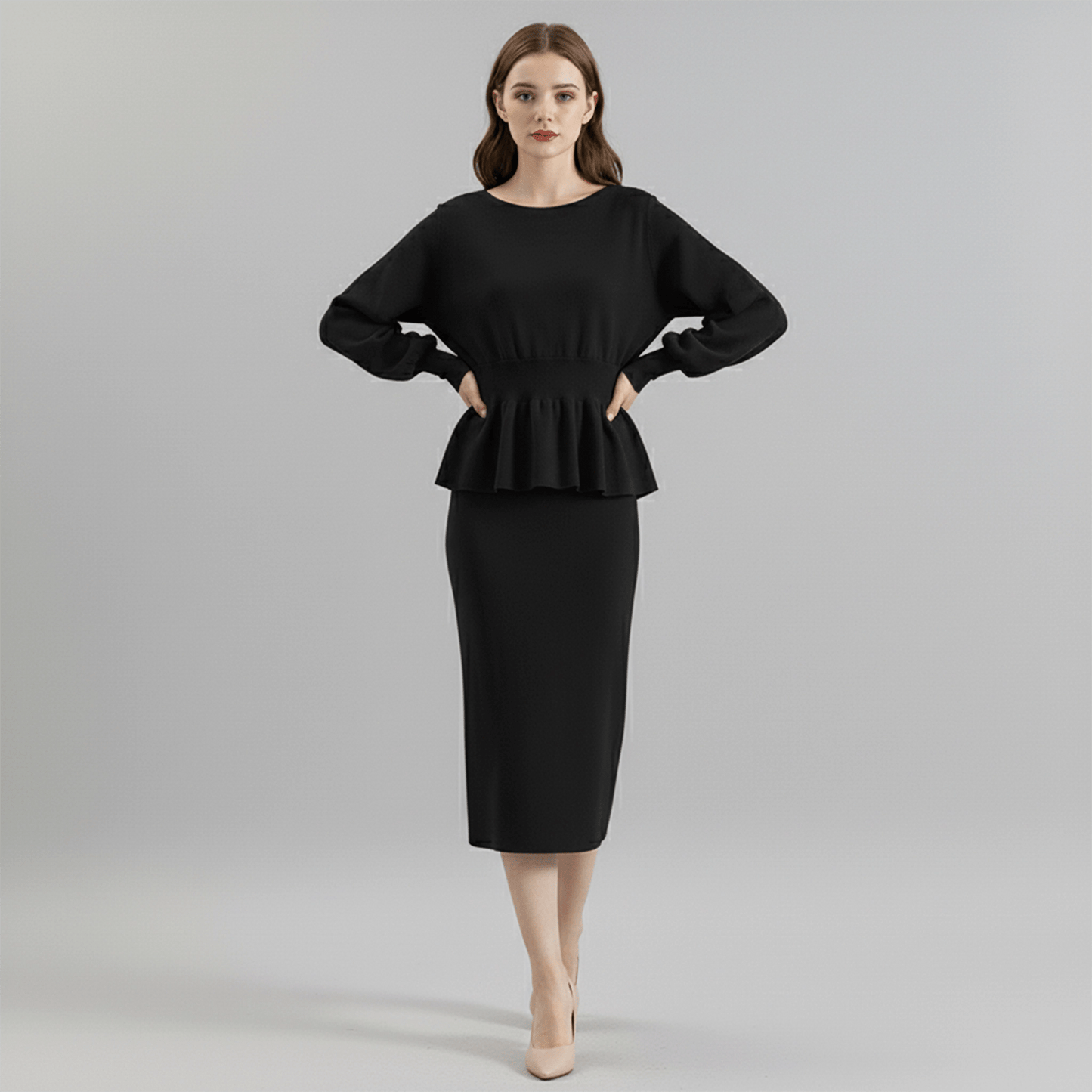Woman wearing a black peplum top and pencil skirt on a gray background