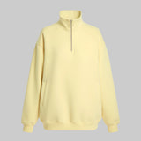 Light yellow half-zip sweatshirt on a white background