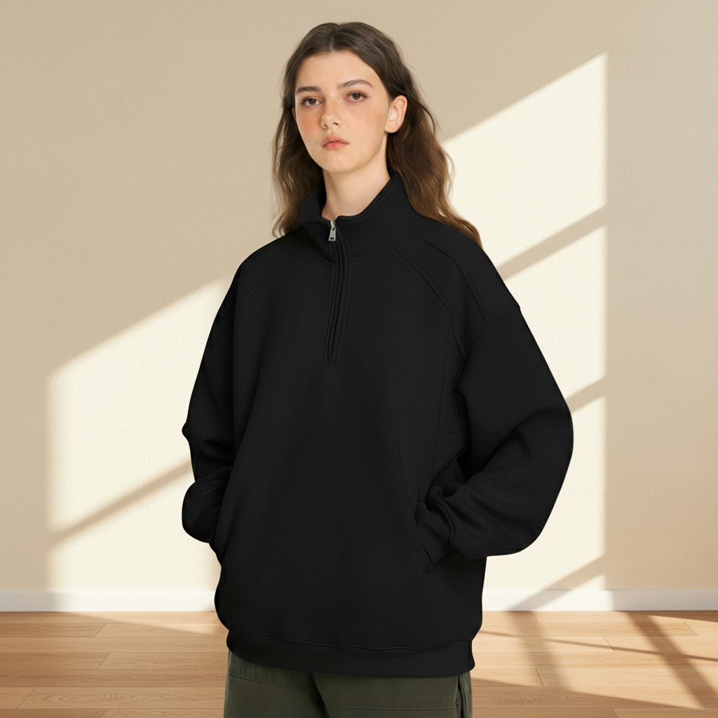 Person wearing a black hoodie on a gray background