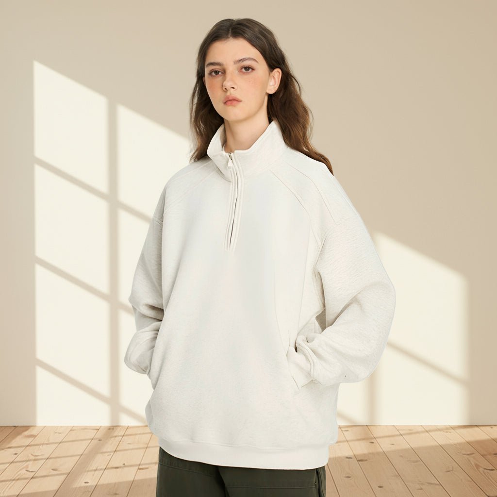 Person wearing a white fleece pullover on a gray background