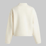 Beige cropped jacket on a gray background