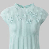 Light blue knitted dress with floral patterns on a white background