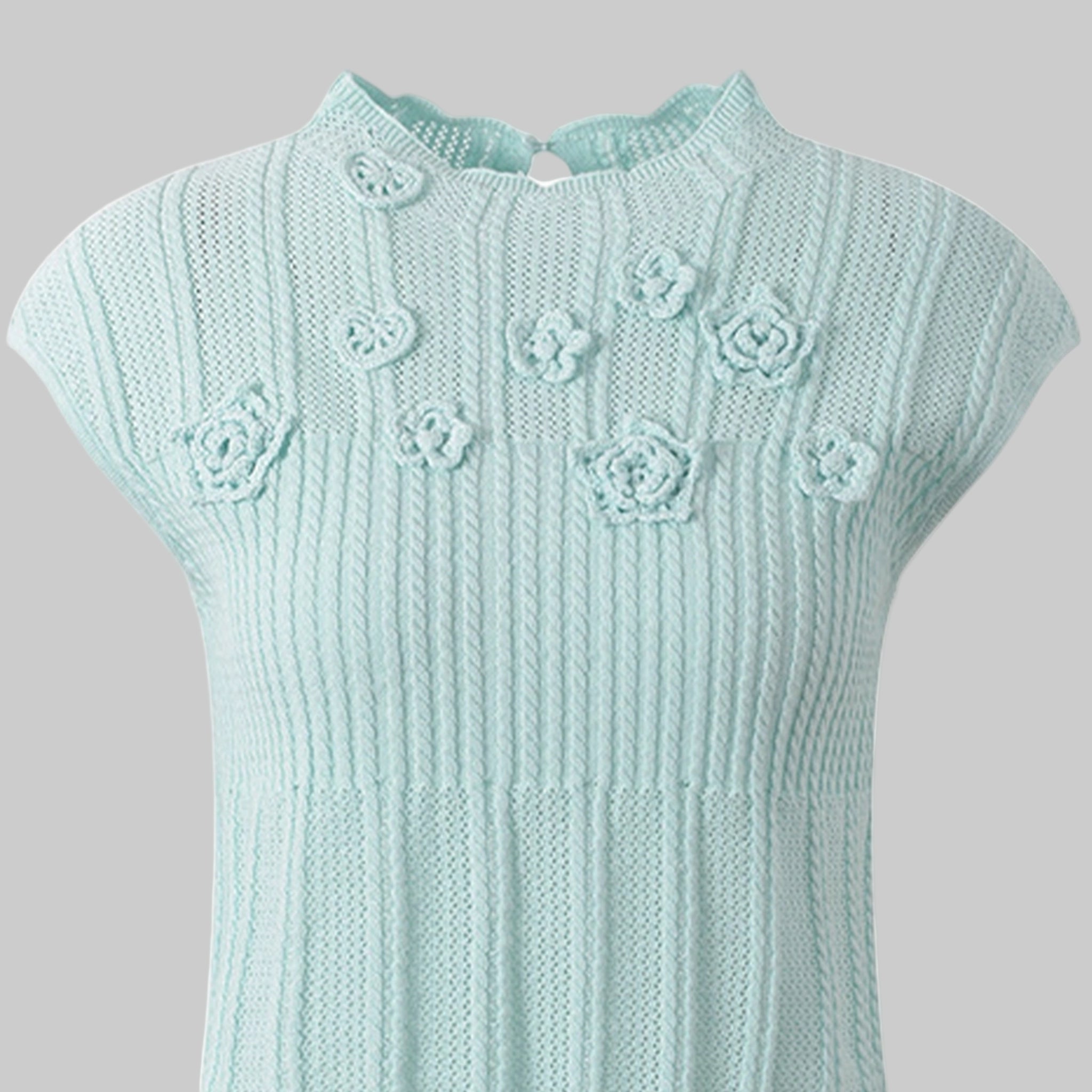 Light blue knitted dress with floral patterns on a white background