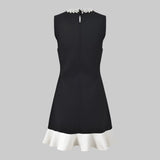 Black dress with white trim on a white background