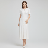 Woman wearing a white dress on a light gray background