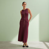 Woman wearing a burgundy dress with button details on a gray background