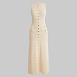 Beige sleeveless dress with button details on a white background
