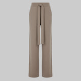 Beige wide-leg pants with a tie waist on a white background
