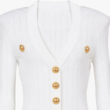 White garment with gold buttons on a white background