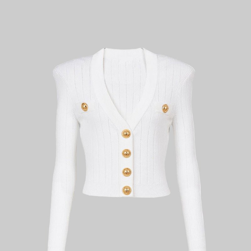 White sleeveless jacket with gold buttons on a light gray background