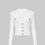 White sleeveless jacket with gold buttons on a light gray background