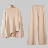 Beige sweater and pants set on a white background